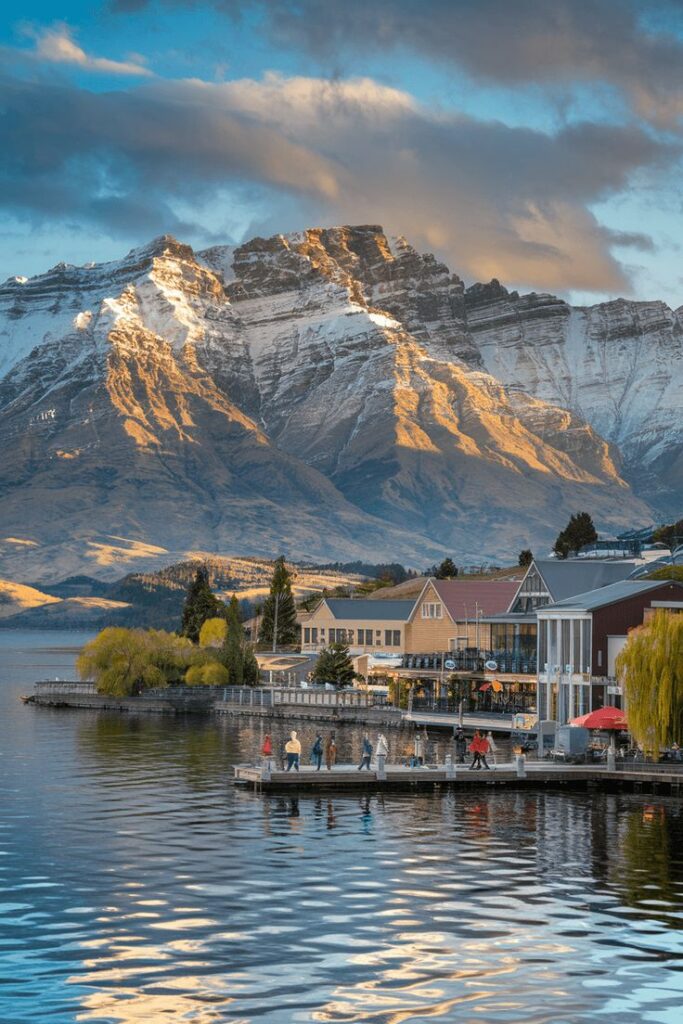 Scenic view of Queenstown waterfront with snow-capped Remarkables mountain range in the background, New Zealand